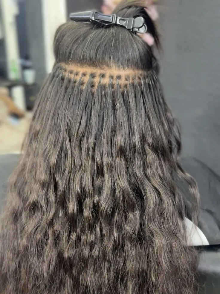K-Tip keratin bond hair extensions being applied row by row